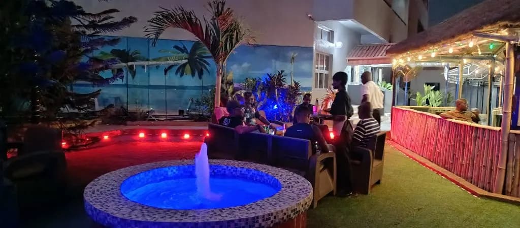 The garden bar and lit fountain after dark